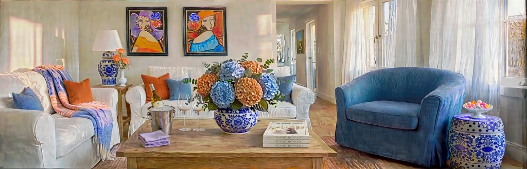 A sitting room designed by Dorothy Howard around her paintings of ladies in hats and her blue and white chinoiserie, set for a book club to gather.
